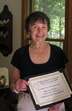 Author Betty Orlemann displays her Silver IPPY award medal
